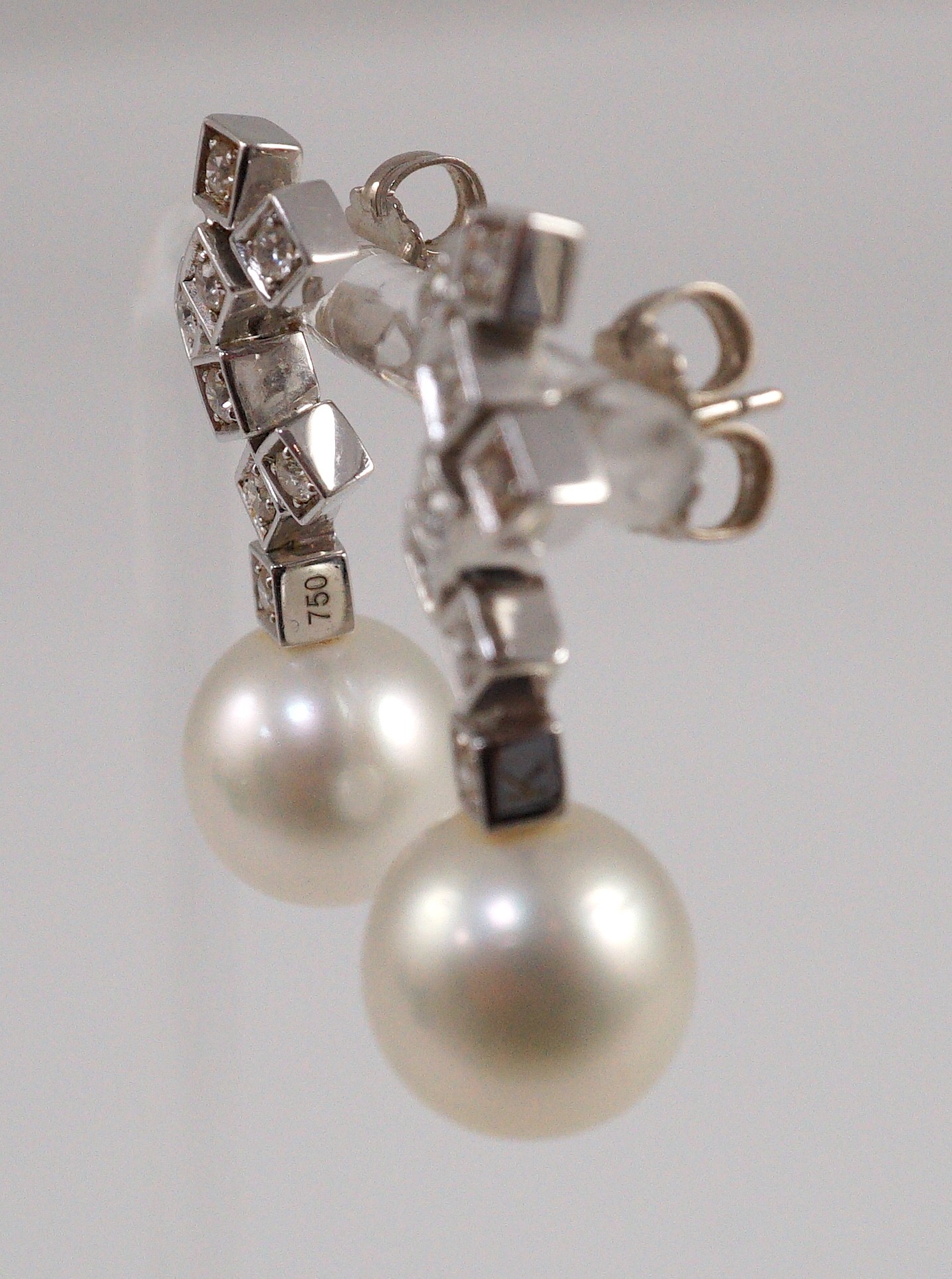 A modern pair of 18ct white gold, single stone South Sea pearl and eight stone diamond cluster set drop earrings, by Kailis